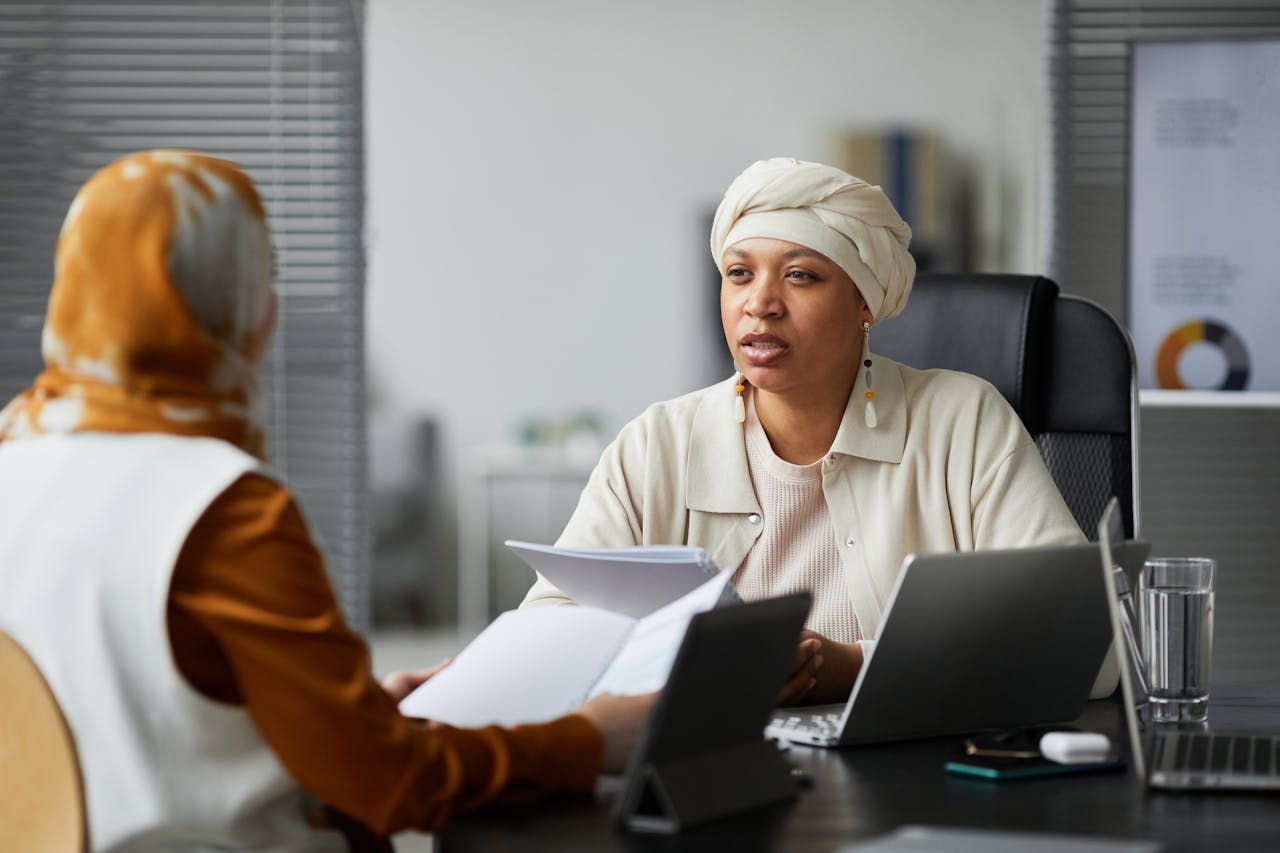 Businesswoman having a conversation in an office setting with colleague.